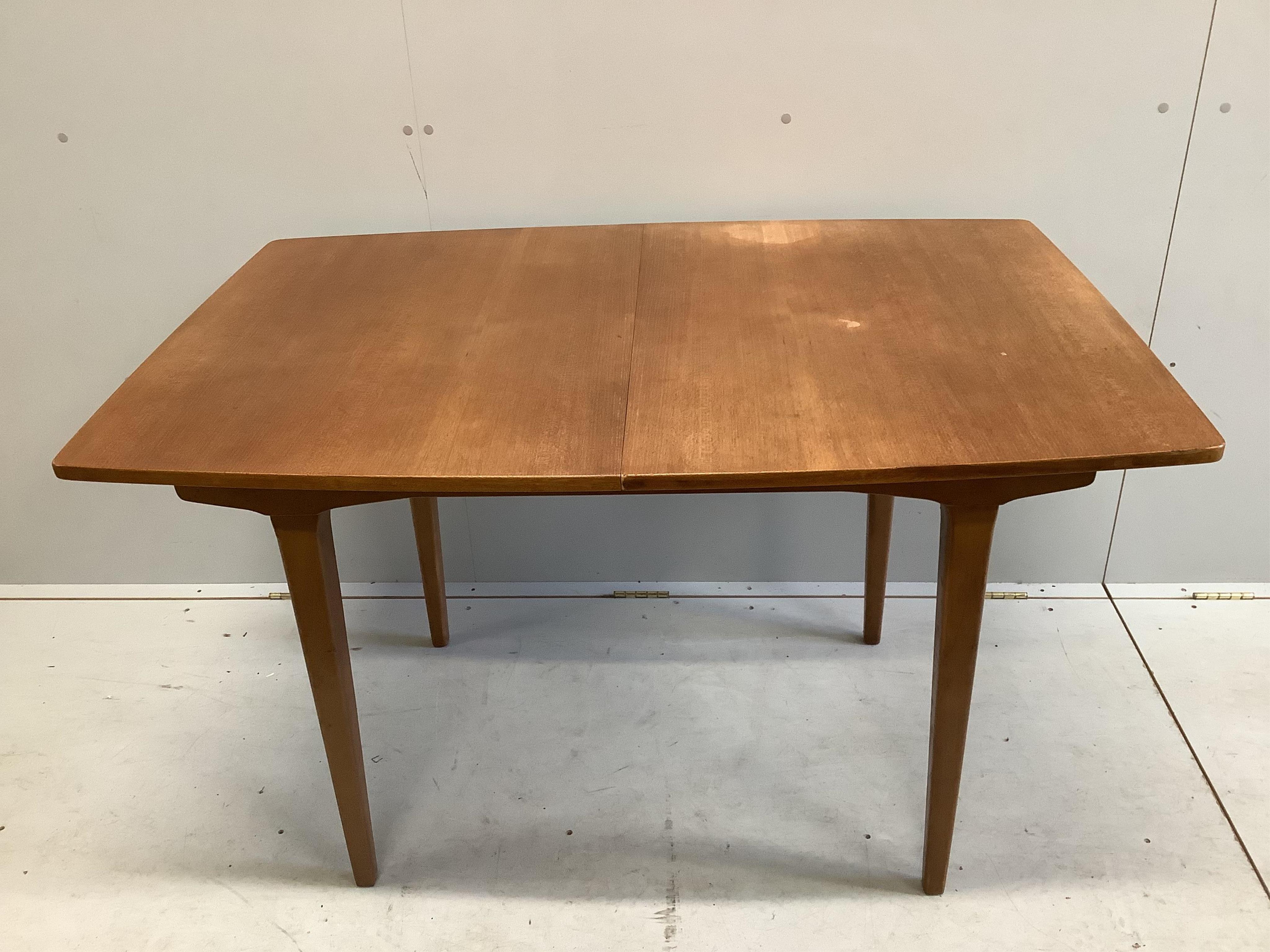 A mid century teak extending dining table, 174cm extended, one spare leaf, depth 83cm, height 74cm. Condition - fair